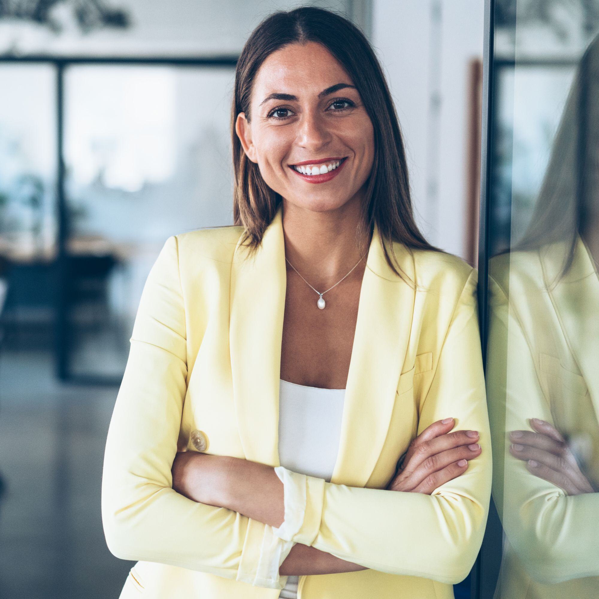 A confident woman with her arms folded thinking 